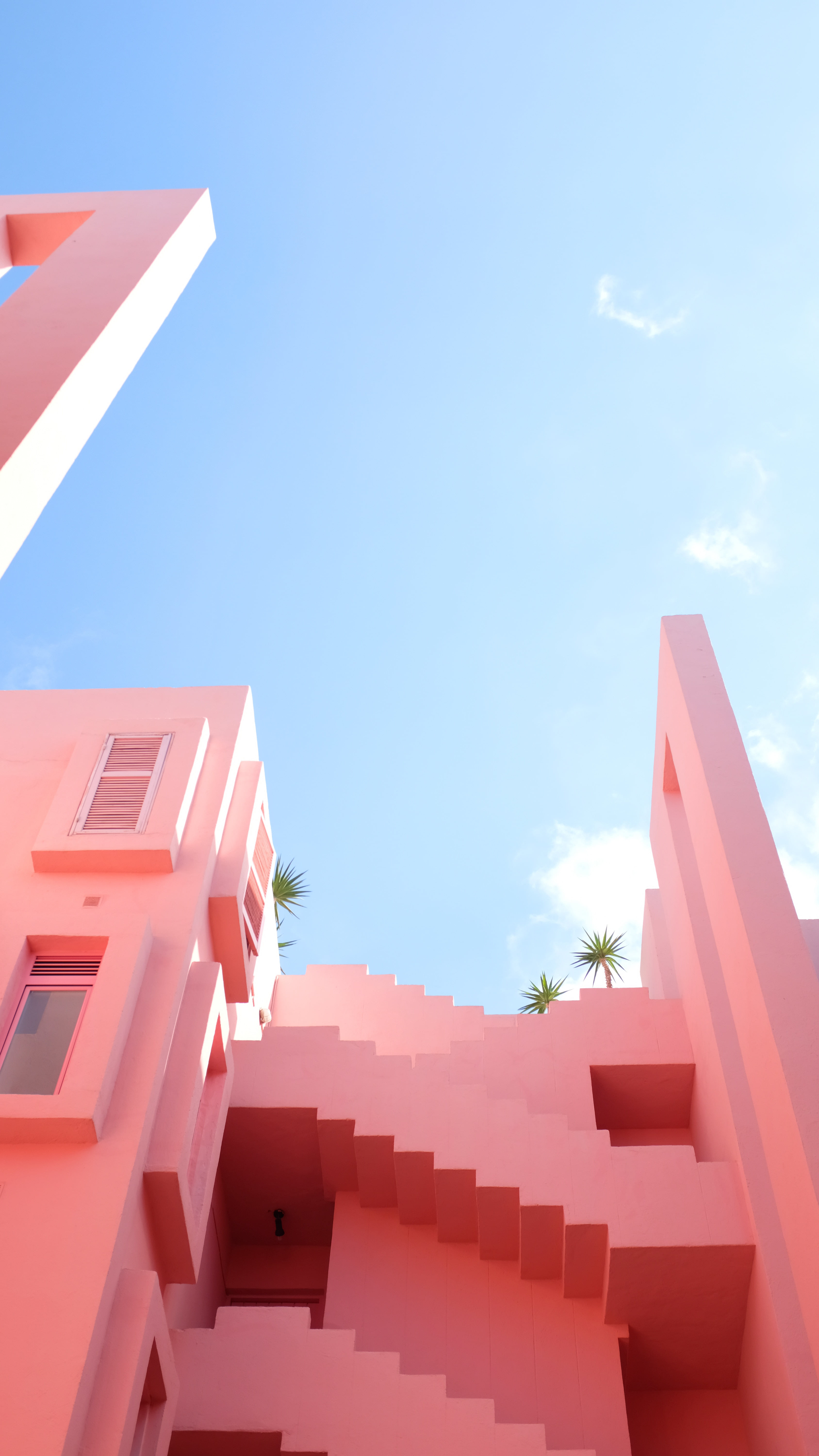 pastelle pink building contrasting with the blue sky